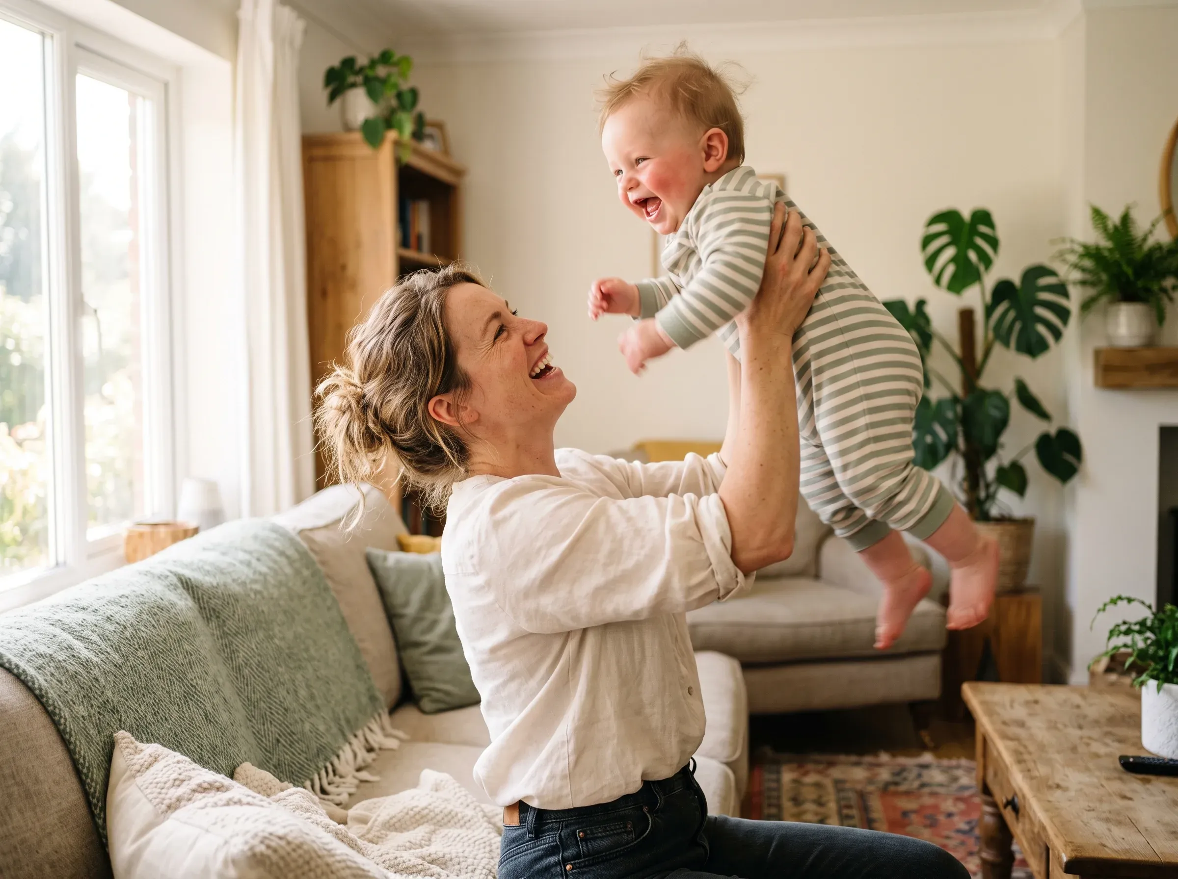 Mother lifting her baby, trusting her body again after childbirth